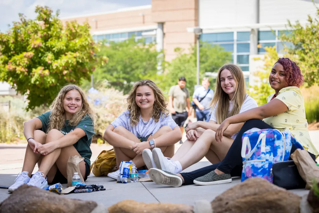 students sitting together on the sidewalk during gateway days